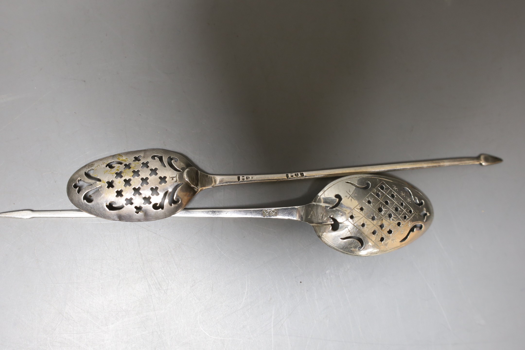 Two 18th century silver mote spoons, one a.f., longest 13.6cm, maker's mark RR for one spoon.